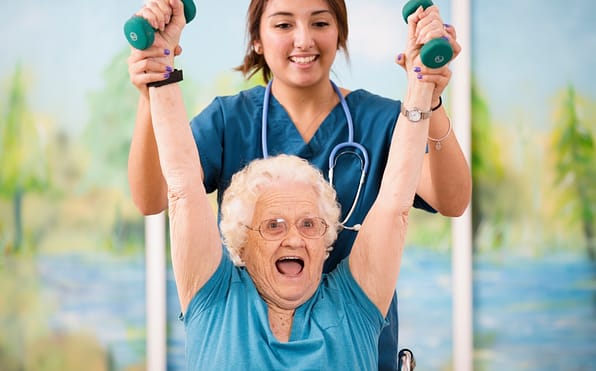A physical therapist supporting a joyful senior as they engage in a physical therapy session, lifting weights to enhance strength, mobility, and overall well-being.