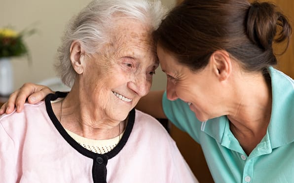 Illinois home healthcare caregiver embracing a dementia patient with heartfelt compassion and understanding, providing a comforting connection and support in their journey.